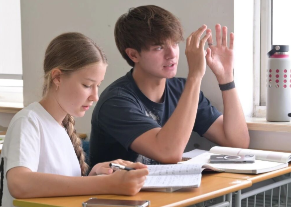 Students working through a Chinese lesson together
