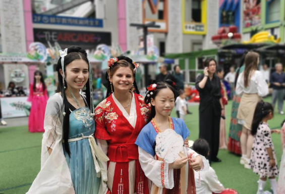 Students trying on Chinese hanfu while studying here