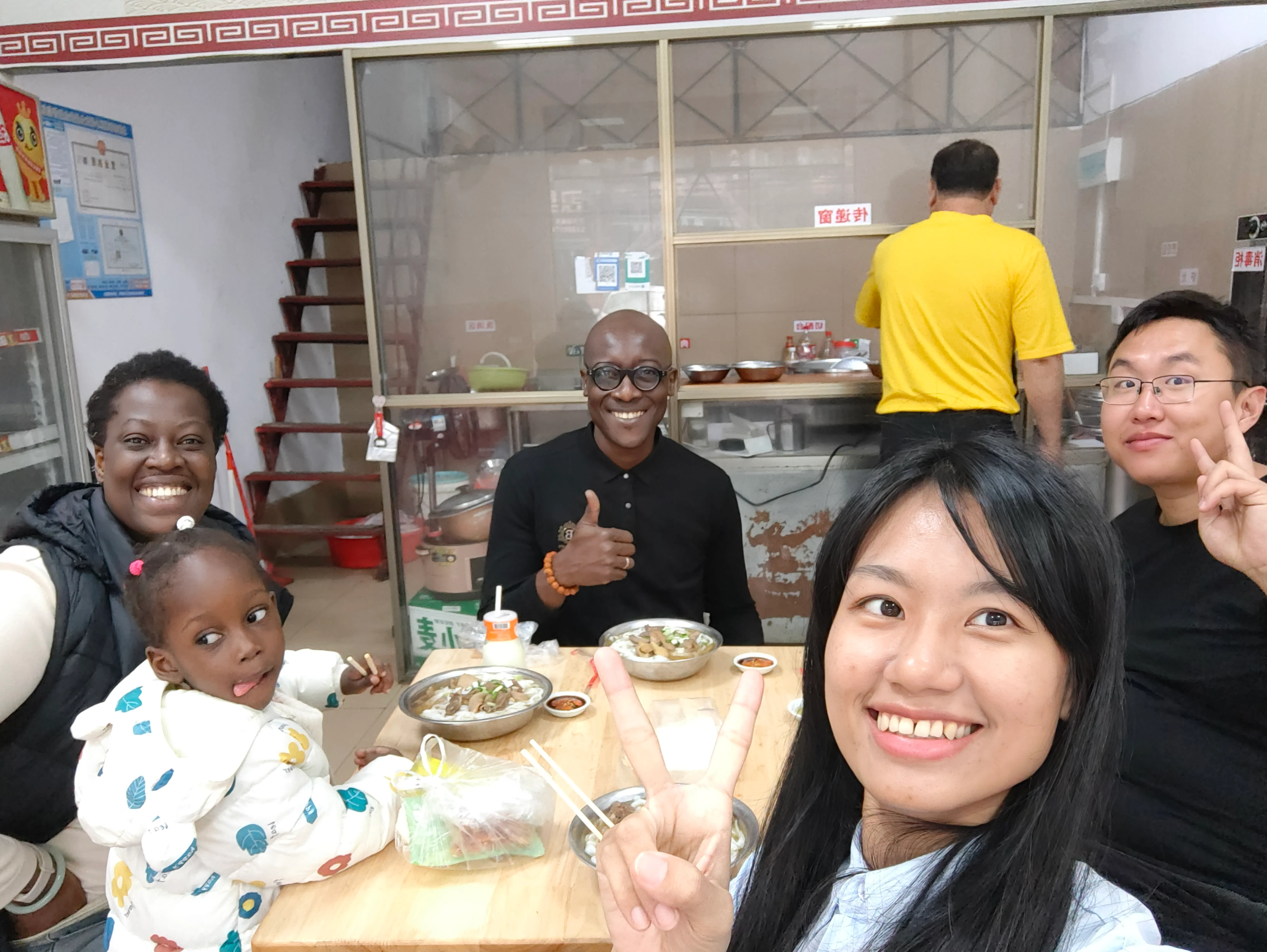 Students over a bowl of beef noodles in Beihai