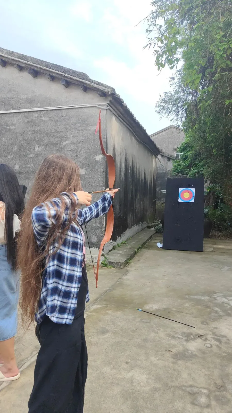 Students trying archery on an afternoon out